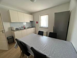 a kitchen with a table and chairs in a room at Villa Ivanka in Koper