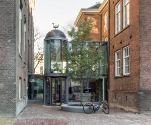 a bike parked in front of a glass building at Wittenberg by Cove in Amsterdam