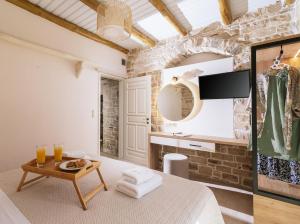 a bedroom with a king sized bed and a table at Koronio Villas in Kalamaki