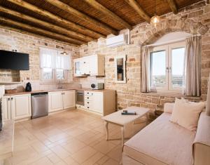 a living room with a couch and a table at Koronio Villas in Kalamaki
