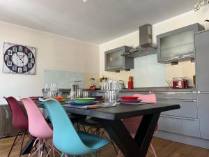a kitchen with a dining room table and chairs at Sunny Side Straelen, 110 qm in Straelen