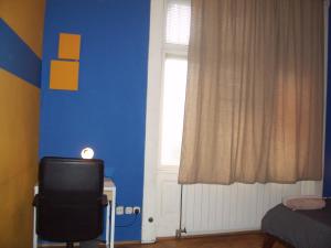 a blue room with a television and a window at Eden Apartment Budapest in Budapest