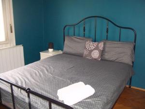 a bedroom with a bed with a blue wall at Eden Apartment Budapest in Budapest +45 photos