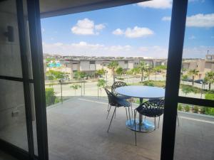a view of a balcony with a table and chairs at Swan Lake North Coast Luxurious Chalet in Zāwiyat al ‘Awwāmah +31 photos