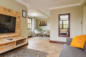 a living room with a large flat screen tv at Silver Guest Studio in George
