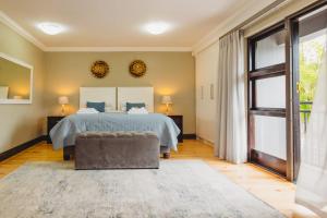 a bedroom with a bed and a large window at Silver Guest Studio in George