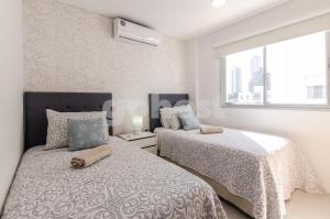 Postel nebo postele na pokoji v ubytování New-exclusive 2-bedroom Apt In Molas Lpez Area