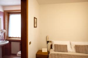 Postel nebo postele na pokoji v ubytování Albergo Trattoria Speranza