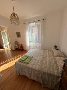 a bedroom with a large bed and a large window at Casa Giulia in Genoa