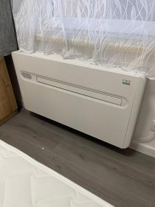 a white drawer in the bottom of a bed at SiDi Doppelzimmer 2 in Erfurt +3 photos