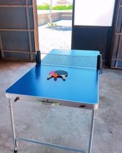 a ping pong table with a ping paddle on it at stone house in Bungotakada +15 photos