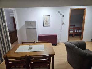 a kitchen and dining room with a table and chairs at Apartmani,,Drljaca,,4 in Soko Banja