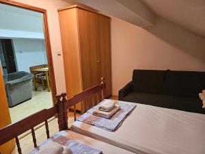 a small bedroom with a bed and a mirror at Apartmani,,Drljaca,,4 in Soko Banja
