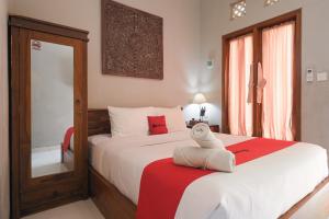 a bedroom with a bed with a towel on a table at RedDoorz near Mertasari Beach 2 in Pesanggaran