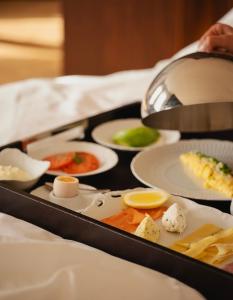 a tray filled with different types of food on a table at Grand Hotel in Łódź +143 photos