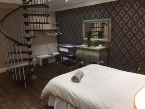 a bedroom with a staircase and a bed and a desk at Brig O'Doon 1 in Ayr +3 photos