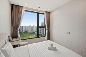 Ένα ή περισσότερα κρεβάτια σε δωμάτιο στο NU Apartment in Lumiere Riverside - Central District 2 +78 φωτογραφίες