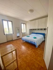 a large bedroom with a bed and a wooden floor at Venice Nora's House in Mestre