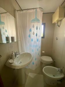 a bathroom with a sink and a toilet and a shower curtain at Venice Nora's House in Mestre +15 photos