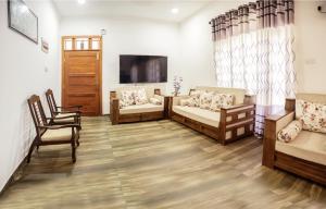 a living room with two couches and a flat screen tv at The Elegance in Kalutara
