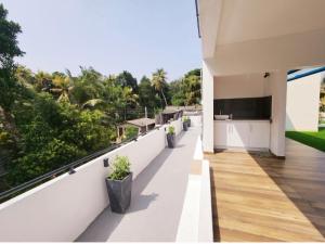 an empty balcony of a house with trees at The Elegance in Kalutara