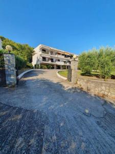 an empty road in front of a building at Paralia Homes Ocean Postcard in Kriopigi