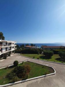 an empty parking lot in front of a building at Paralia Homes Ocean Postcard in Kriopigi +11 photos