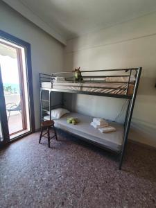 a room with two bunk beds with a window at Paralia Homes Ocean Postcard in Kriopigi