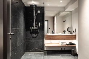 a bathroom with a shower and a sink at Rauriserhof 4 Sterne Superior in Rauris