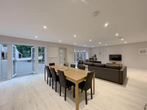 a dining room and living room with a table and chairs at The Gatehouse Lodge in Norwich