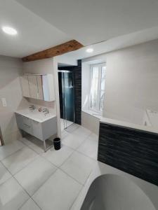 a white bathroom with a sink and a mirror at Les 27 in Ginestas +14 photos