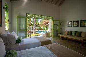 a bedroom with two beds and a living room at Zen Villa in Ahangama +54 photos