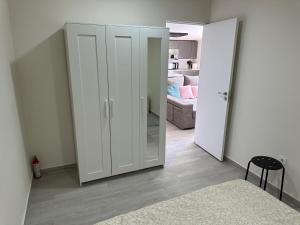 a room with a white closet with a mirror at New modern apartment, Scandinavian style, ocean view, huge terrace in Icod de los Vinos