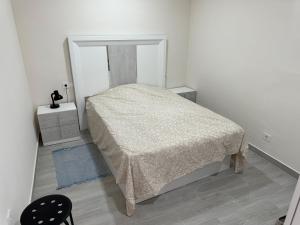 a small bedroom with a bed and a mirror at New modern apartment, Scandinavian style, ocean view, huge terrace in Icod de los Vinos