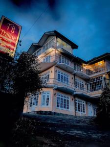 a large building with a sign in front of it at Thilina Hotel in Nuwara Eliya