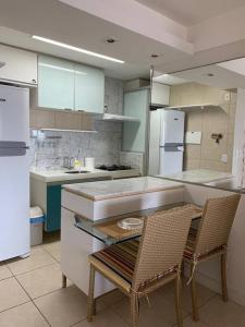 a kitchen with a table and two chairs in it at Beach Village - Praia do Futuro II in Fortaleza