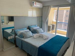a bedroom with two beds with blue sheets and a window at Beach Village - Praia do Futuro II in Fortaleza +44 photos