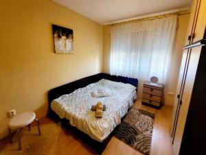 Un dormitorio pequeño con una cama y una ventana. en Sweet Maria Blagoevgrad, en Blagoevgrad