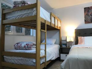 a bedroom with two bunk beds and a bed at Albano apartamento 1 en casa vacacional Chosica in Mariscal Castilla