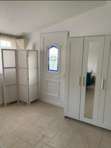 a room with white closets and a window at Studio le soleil couchant in Saint-Saturnin-lès-Avignon +8 photos