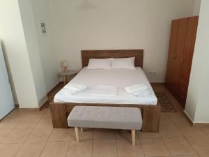 a bedroom with a large bed with a wooden frame at Διατίθεται Γκαρσονιέρα in Kalamata