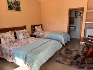 Cama o camas de una habitación en Pousada Cascata de Pedra
