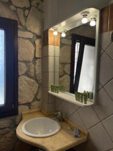 a bathroom with a sink and a mirror at Villa Sunrise in Agia Paraskevi +28 photos