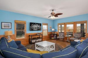 a living room with blue walls and a blue couch at NH333 Capt Brad's in Nags Head
