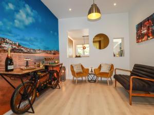 a living room with a table and a bike in it at Sea Candy in St Ives
