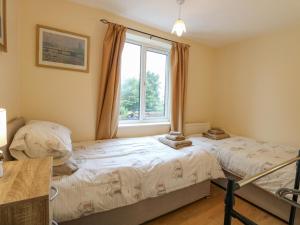 Postel nebo postele na pokoji v ubytování Tiffany's Cottage