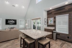 a kitchen with a large island with bar stools at NH387B Ocracoke Cottage in Nags Head