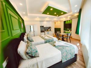 a hotel room with two beds and a kitchen at Valentina Apart Hotel in Istanbul