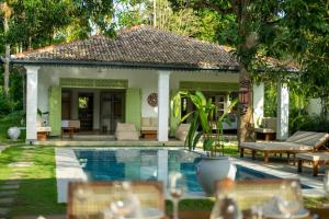 a villa with a swimming pool and a house at Zen Villa in Ahangama