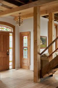 a room with a staircase and stained glass windows at Hicks Holme - Beach Front Victorian in Waupoos